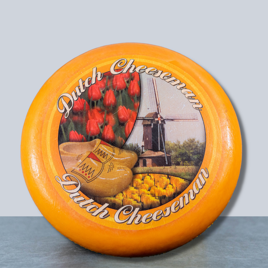 Aging Gouda cheese wheels in a cellar